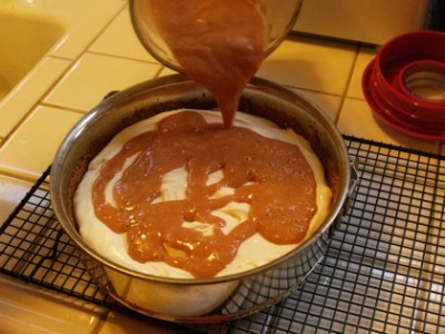 pouring guava on cheesecake