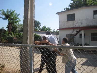 A physical hold being placed on Bartolo Marquez in front of the home of Sarah Martha Fonseca