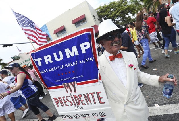 MIAMI, UNITED STATES - MARCH 13: Santiago Portal, who migrated from Cuba 50 years ago, displays a sign supporting US Presidential candidate Donald Trump on 8th Street in the Little Havana community during the Calle Ocho Festival on March 13, 2016 in Miami, Florida. (Photo by Sean Drakes/LatinContent/Getty Images)